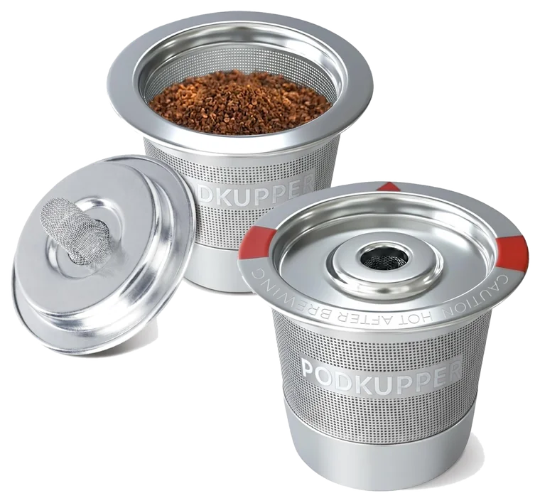 Two PodKupper stainless steel reusable coffee pods, one filled with ground coffee, lids off